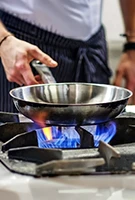 gas stove in use with pan 135x200